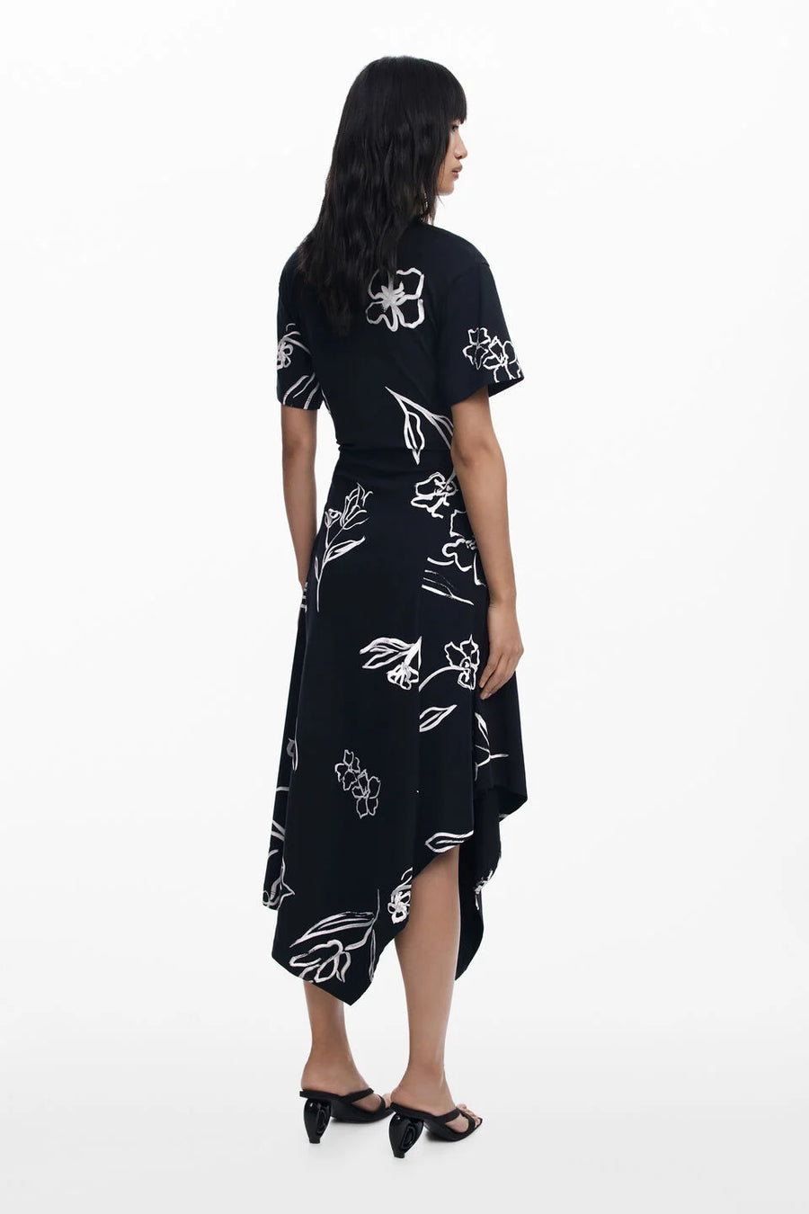 Back view of woman wearing a black floral dress 