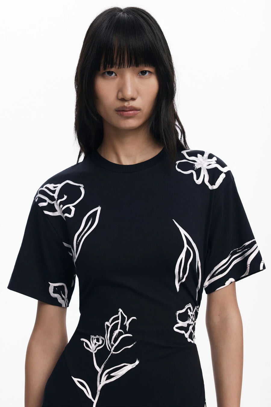Front view of woman wearing a black floral dress 