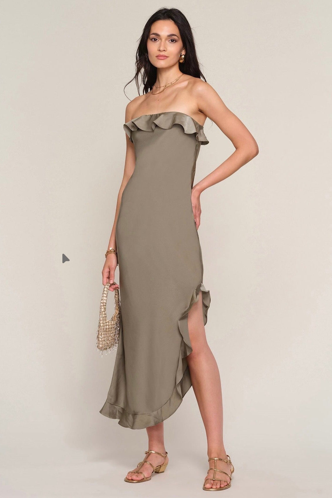 Woman wearing a strapless ruffle dress in olive green