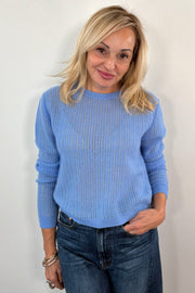 Woman wearing a blue cashmere sweater