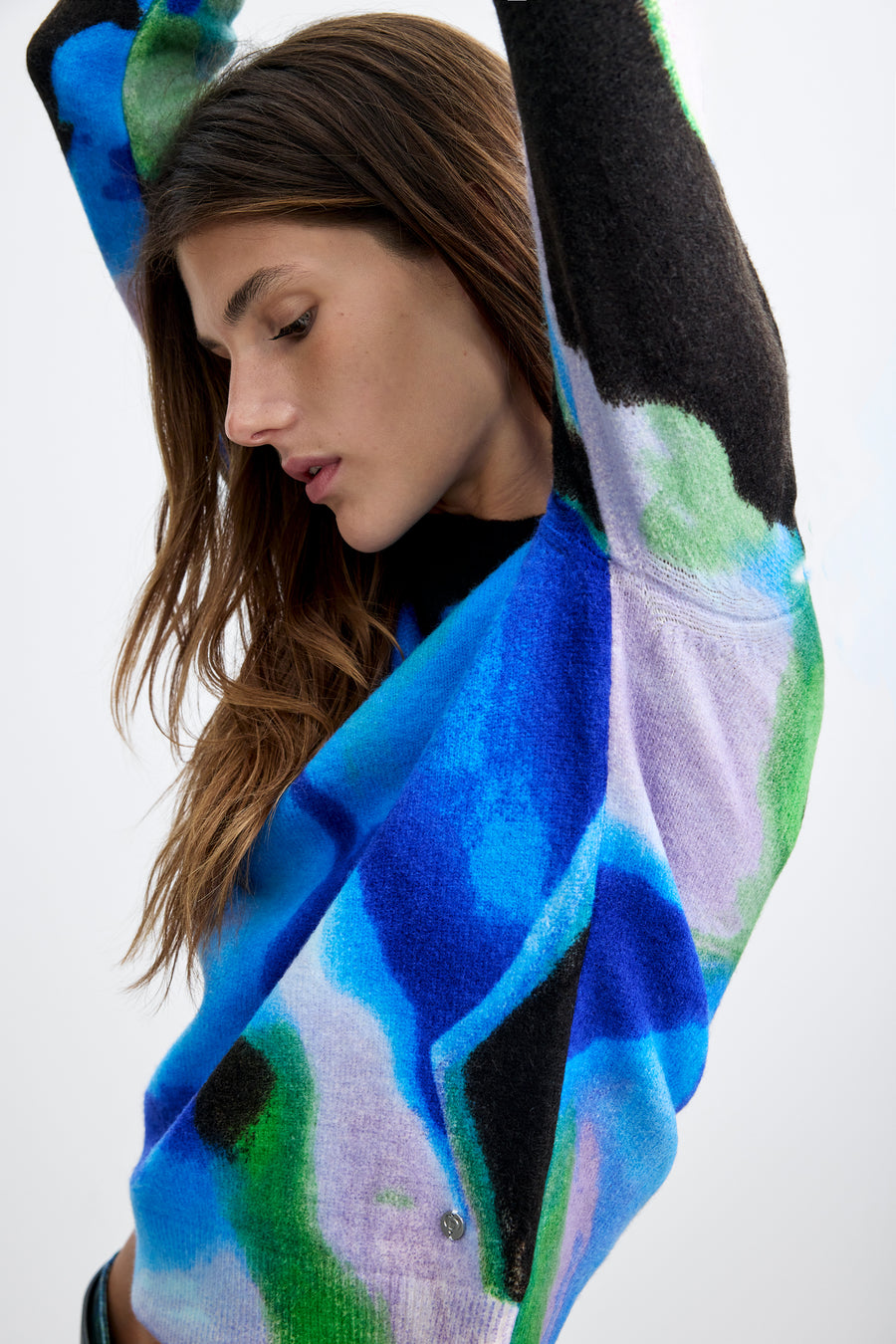 long sleeve pullover with an abstract water color in black, blue, green, and white with a crew neckline. 