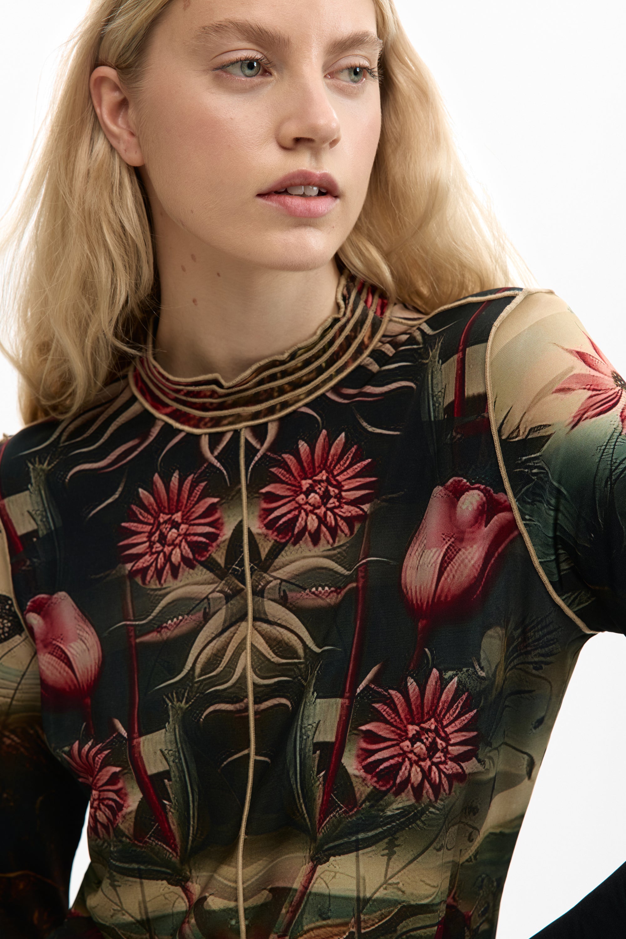 long sleeve mesh top with a vibrant botanical print with colorful florals and foliage on a black background 