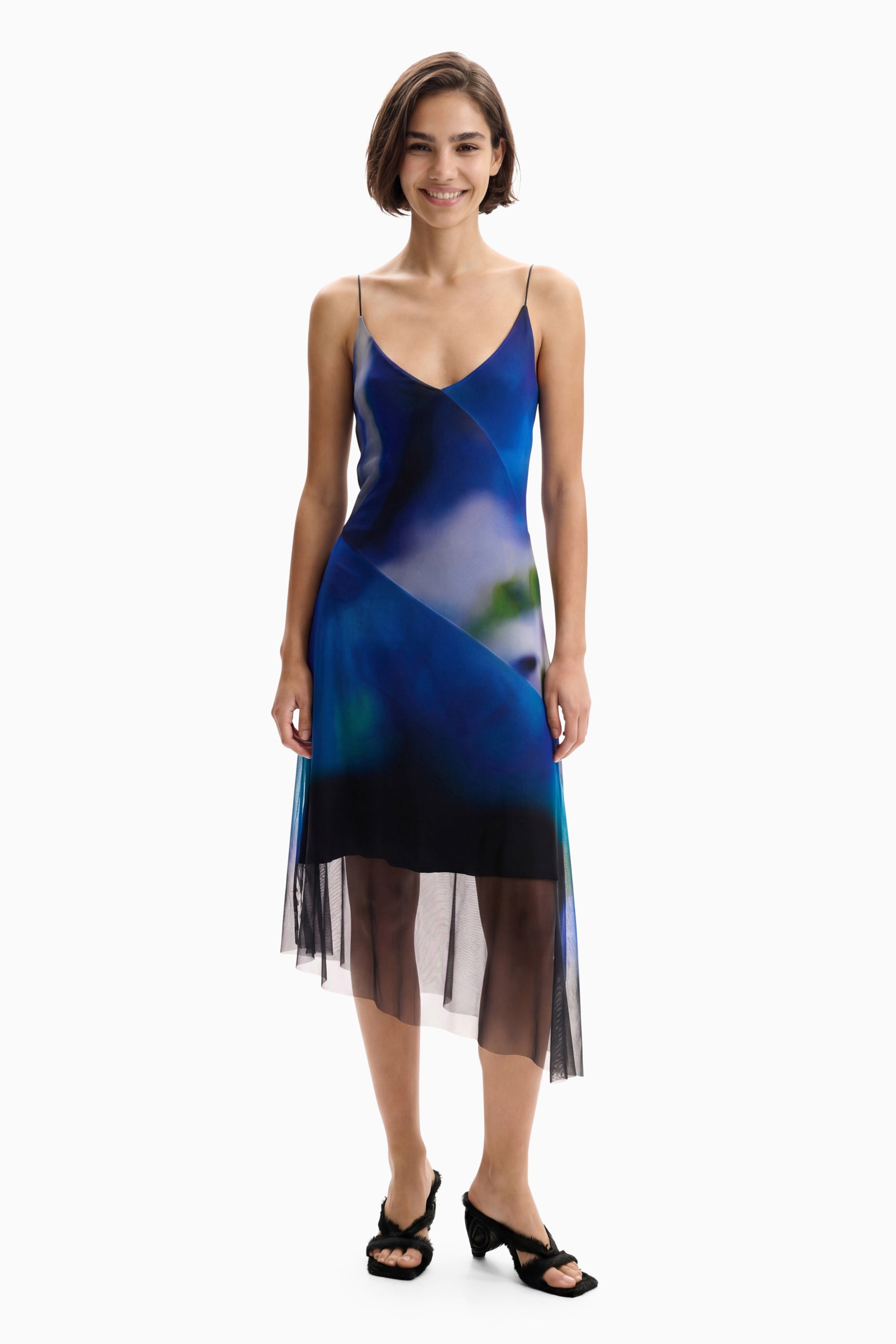 blue watercolor midi slip dress featuring a v-neckline, spaghetti straps, and a sheer mesh asymmetrical hem 