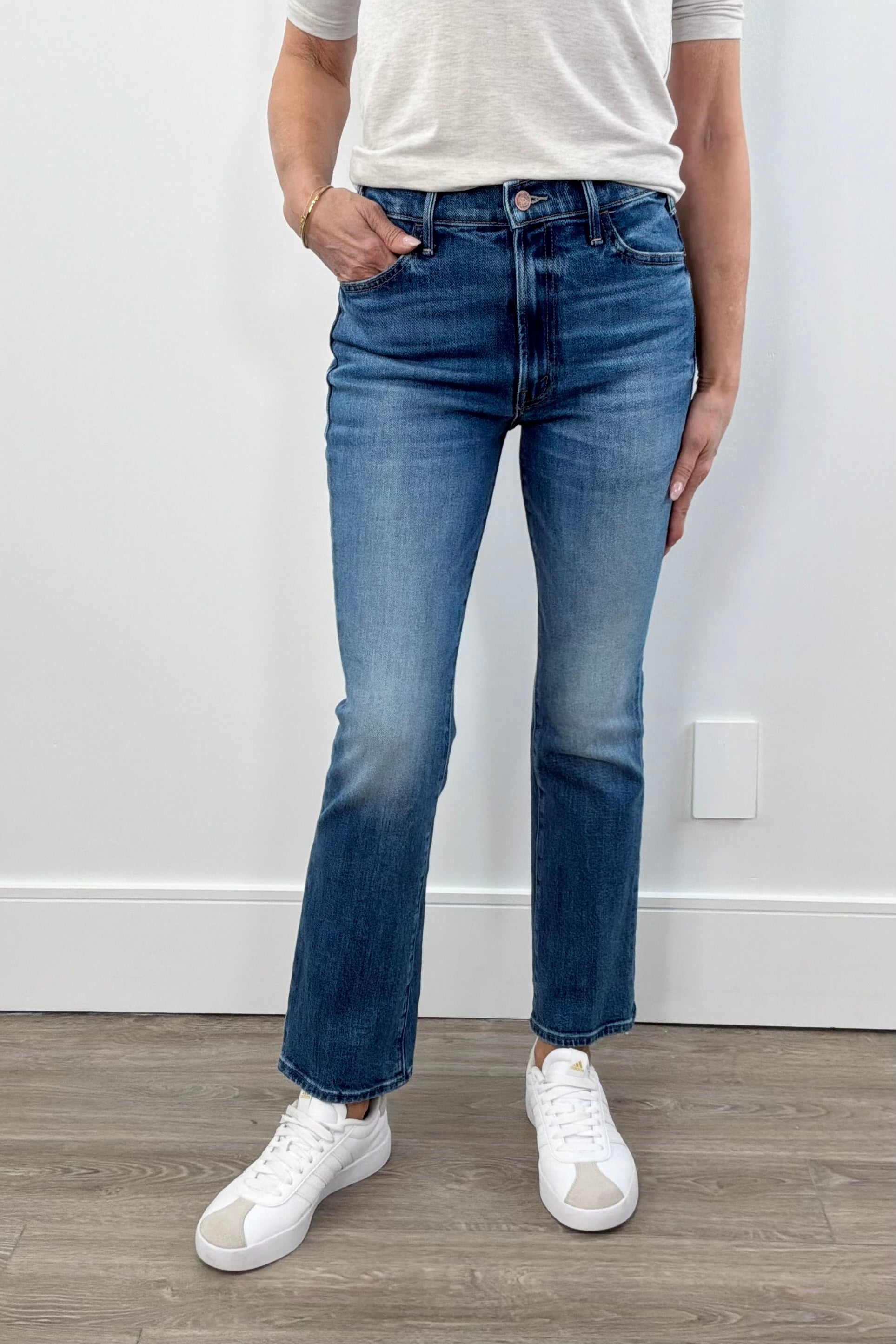 woman wearing washed blue denim with a small flare at the bottom
