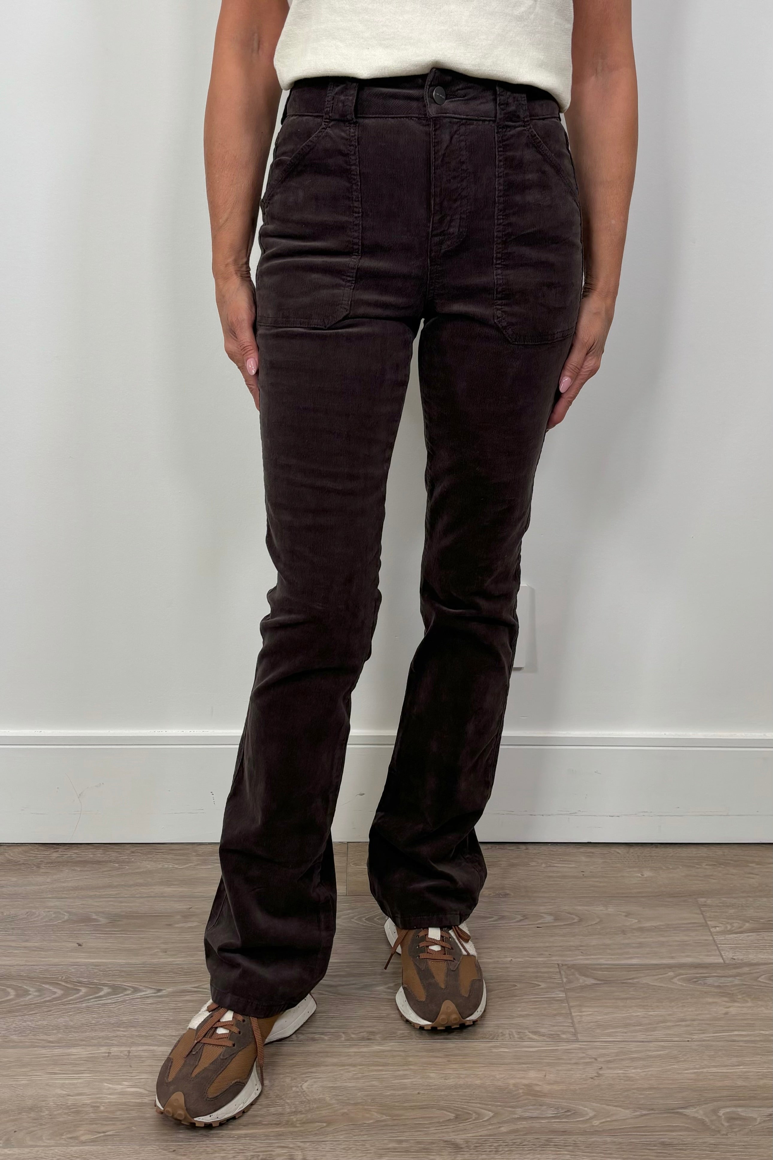 woman wearing a fitted flared corduroy brown pants