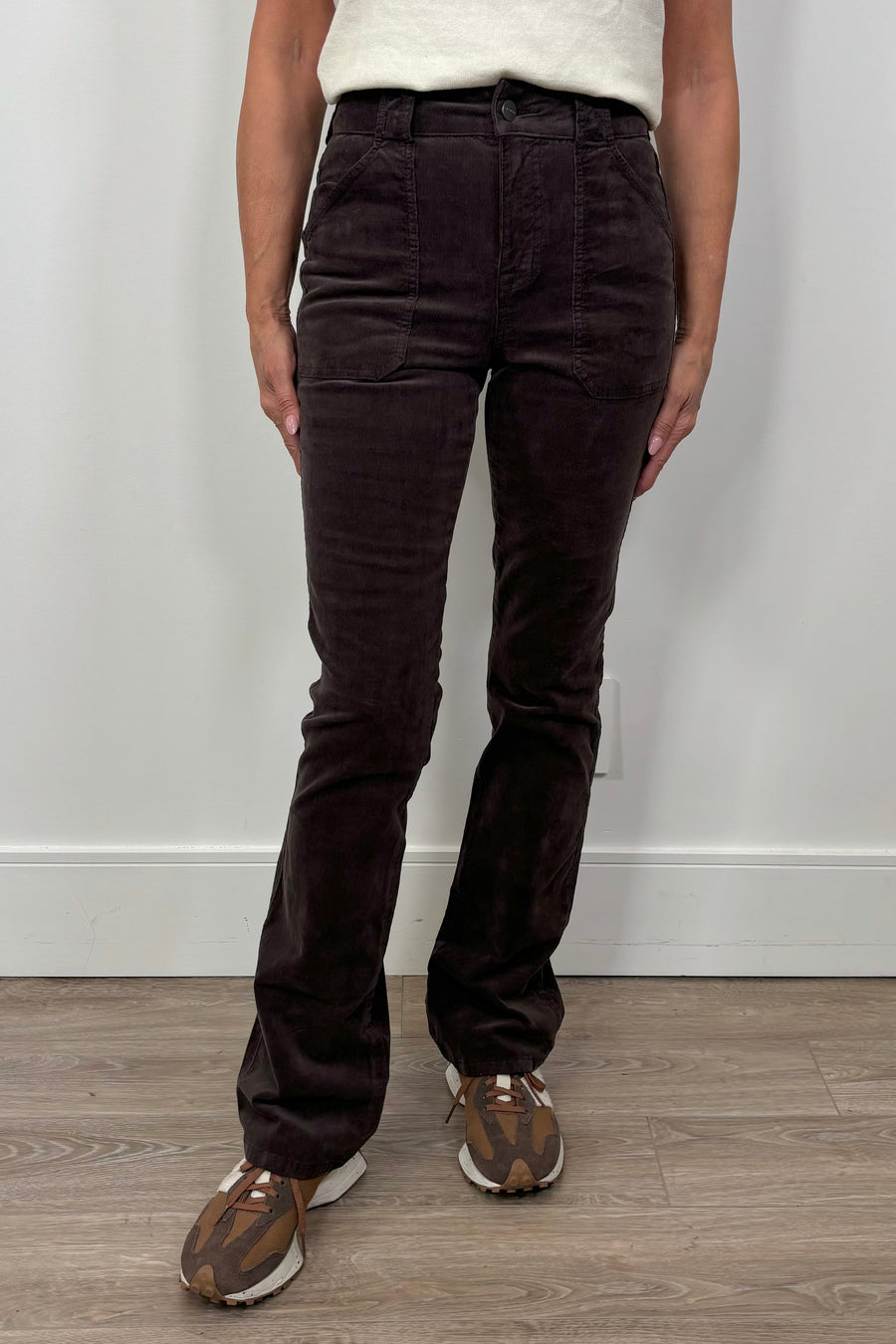 woman wearing a fitted flared corduroy brown pants