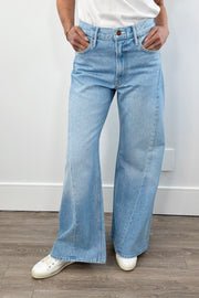 woman wearing light blue washed wide leg denim