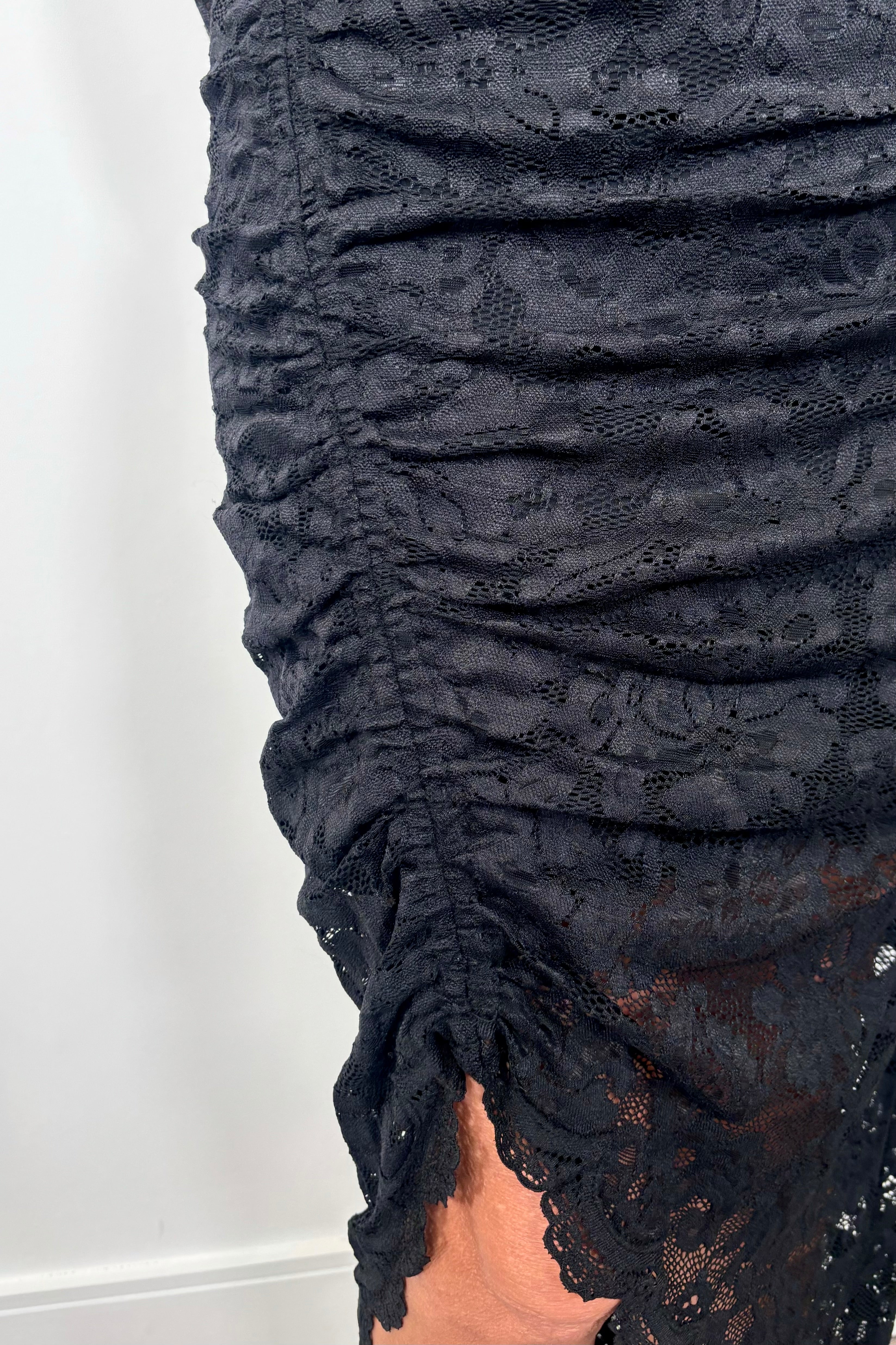 close-up of a long sleeve lined black lace dress