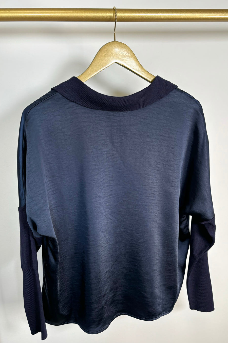 back view of a deep navy long sleeve v-neck top 