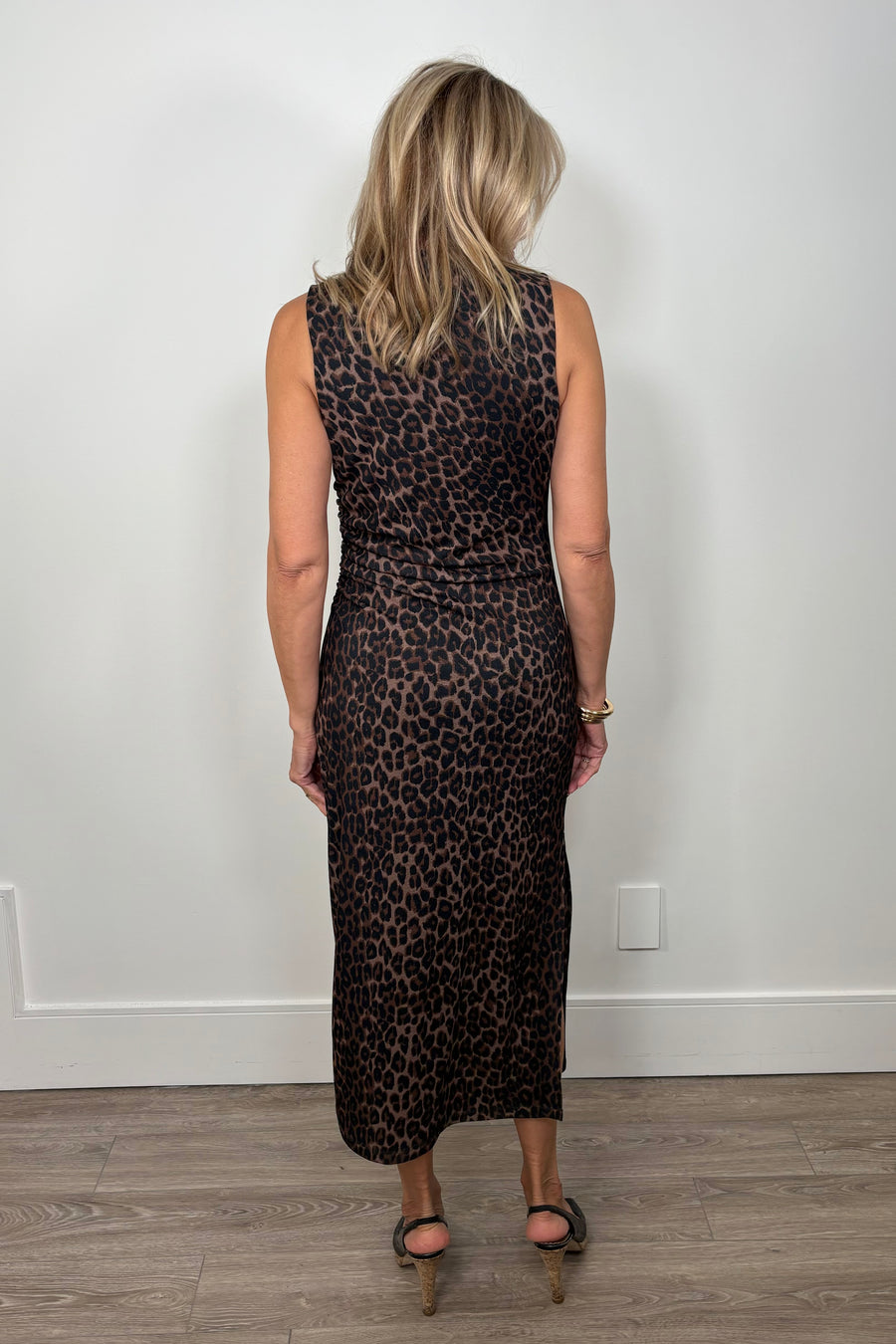 Back view of a woman wearing a leopard brown mesh dress
