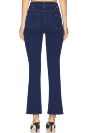 Back view of Woman wearing a dark indigo ankle flare jean