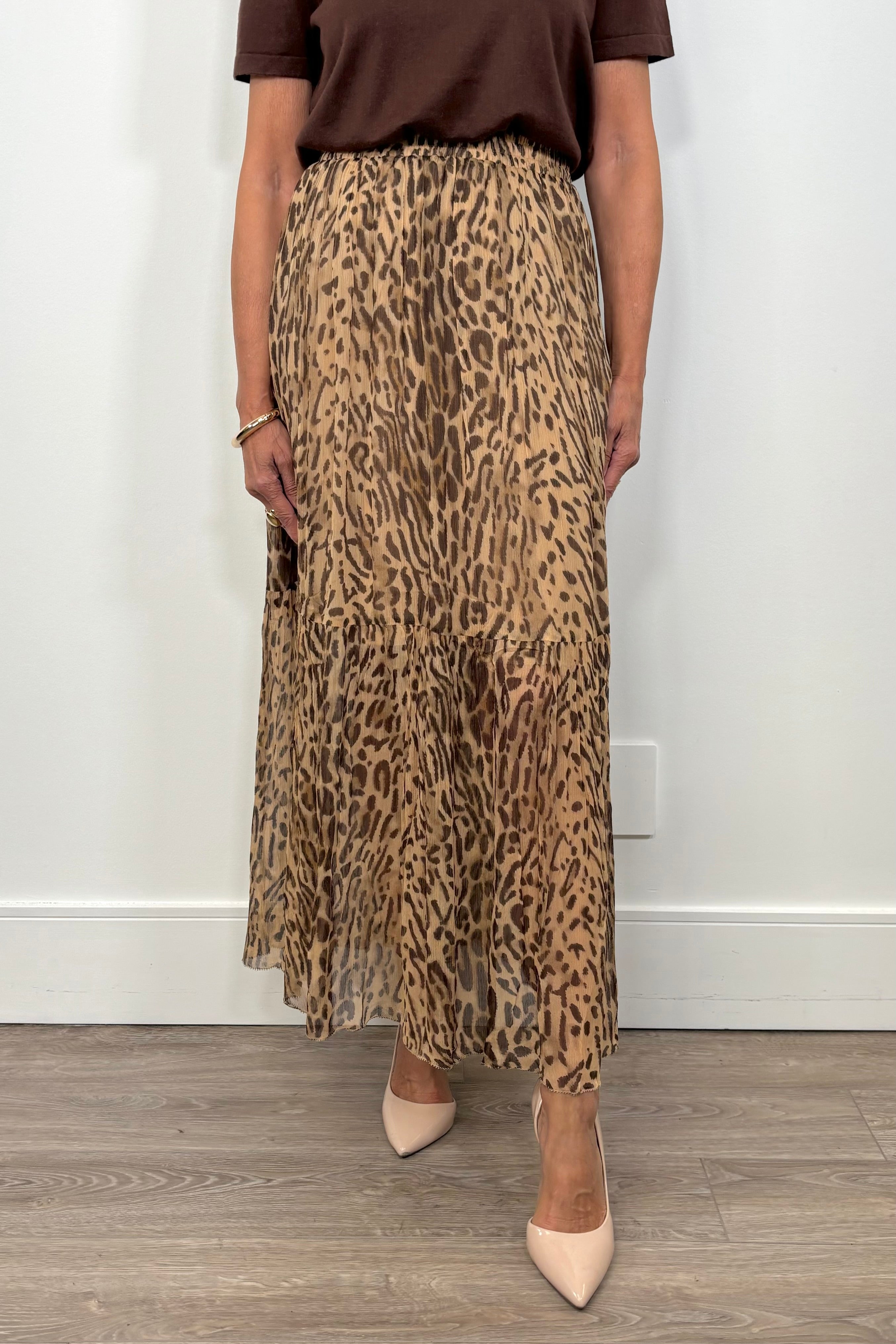 Front view of woman wearing a leopard print maxi skirt