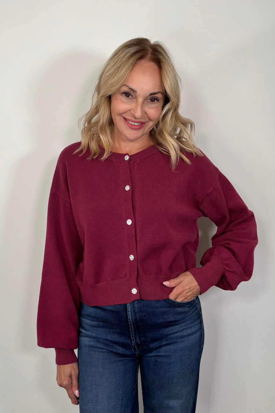 woman wearing a burgundy crystal button cardigan
