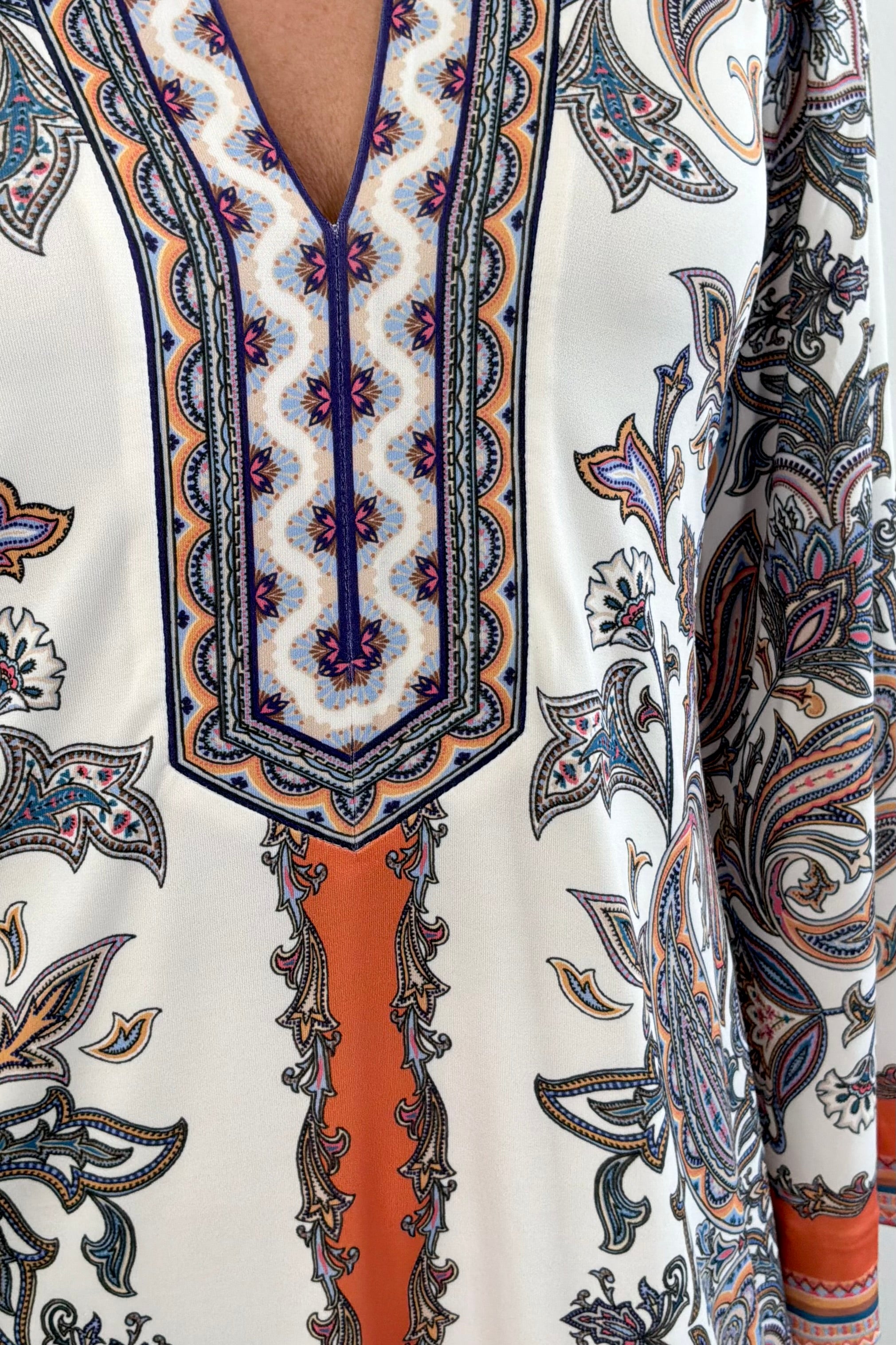 Woman wearing a patterned ivory dress