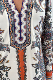 Woman wearing a patterned ivory dress