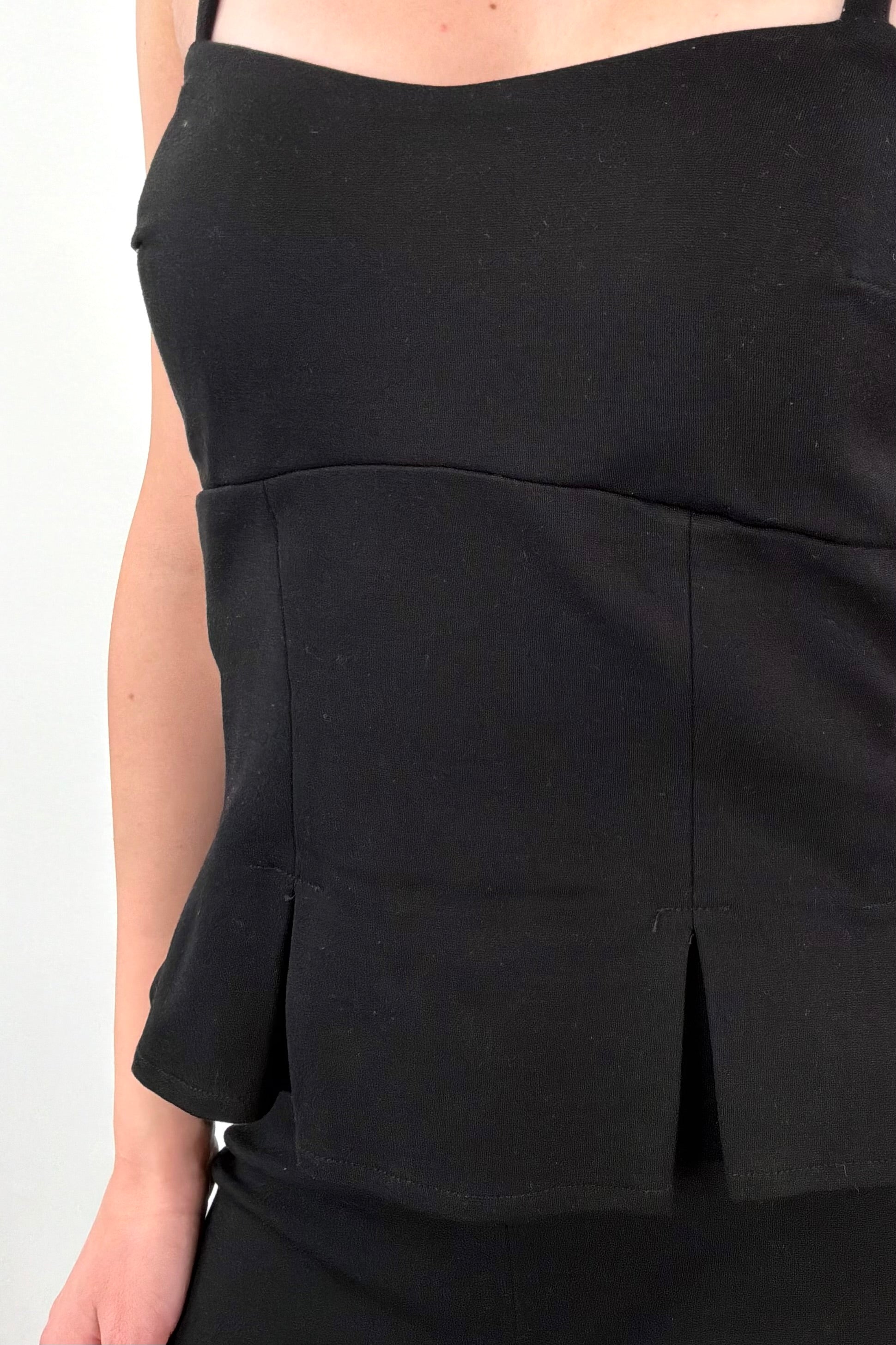 Close up of Woman wearing a black sleeveless top