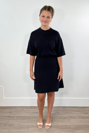 Woman wearing a black knit dress