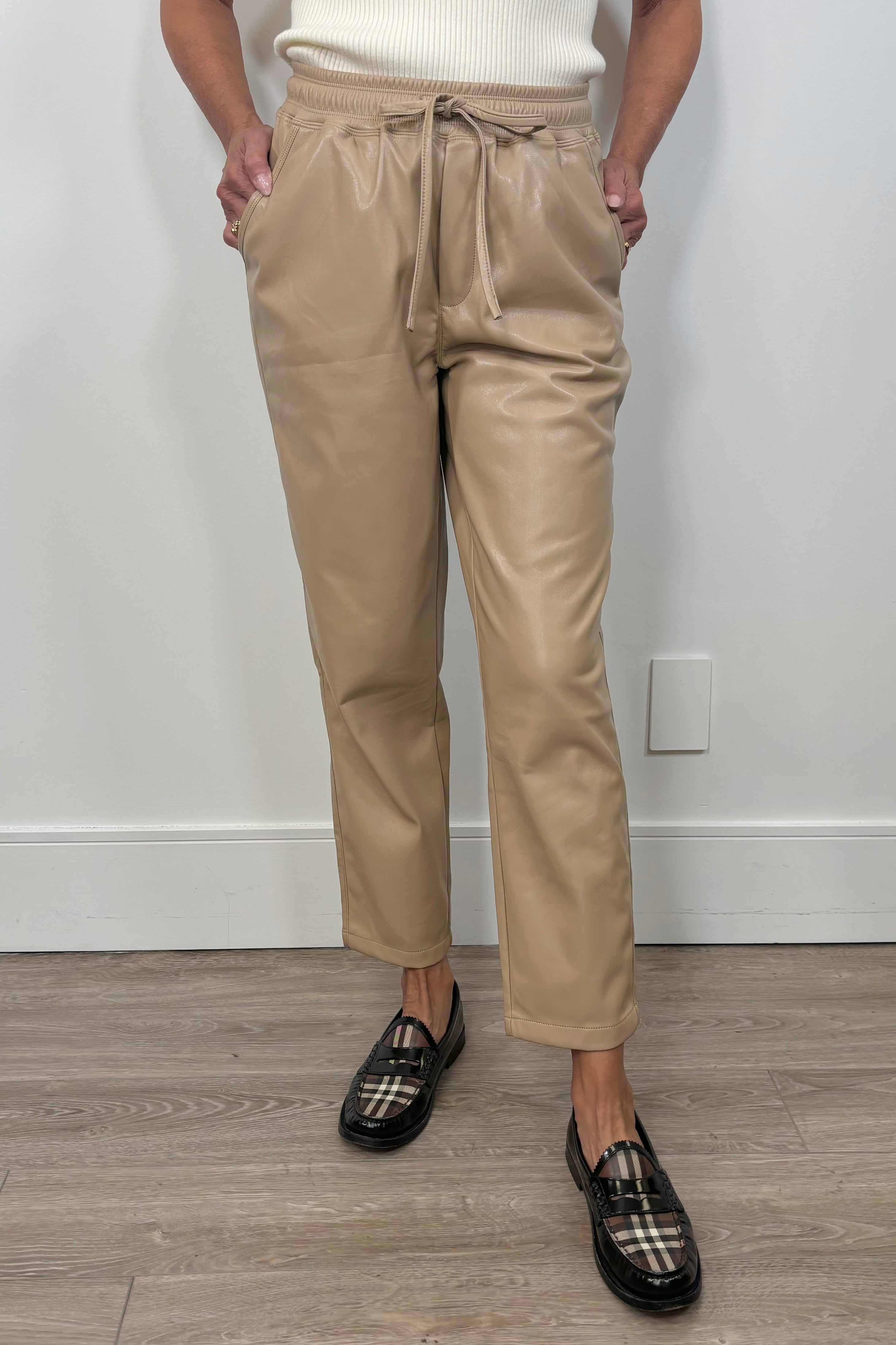 Woman wearing a beige leather drawstring pant