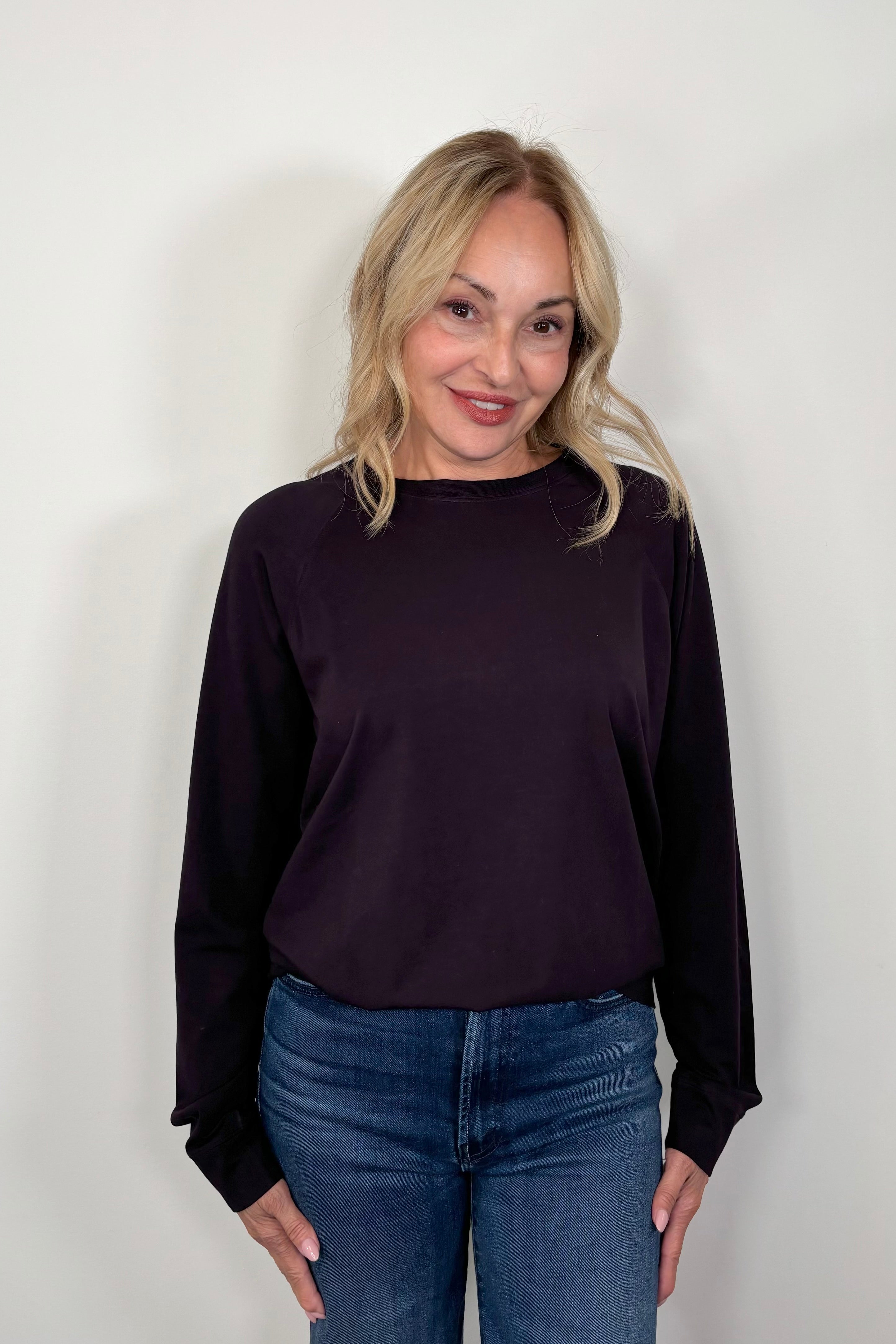 woman wearing a deep purple cotton sweatshirt