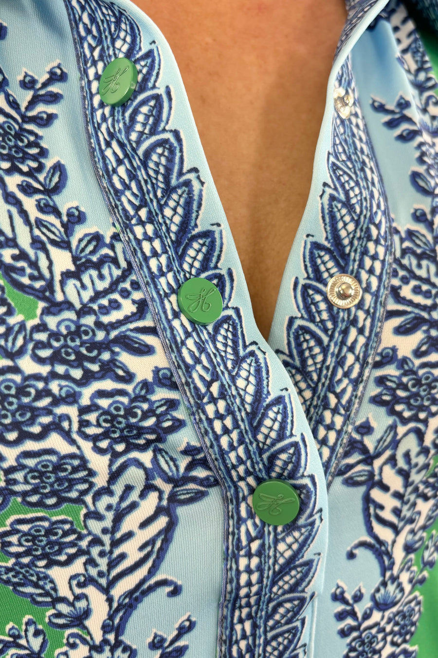 Close up of Woman wearing a blue and green patterned short dress with a 3/4 sleeves