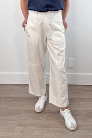 Woman wearing cream high-waisted straight-leg pants, front view