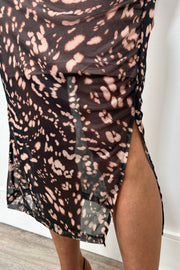 close-up of the slit of a leopard print mesh dress