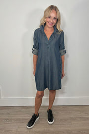 Front view of woman wearing a blue midi tencel yoke dress with cuffed sleeves 