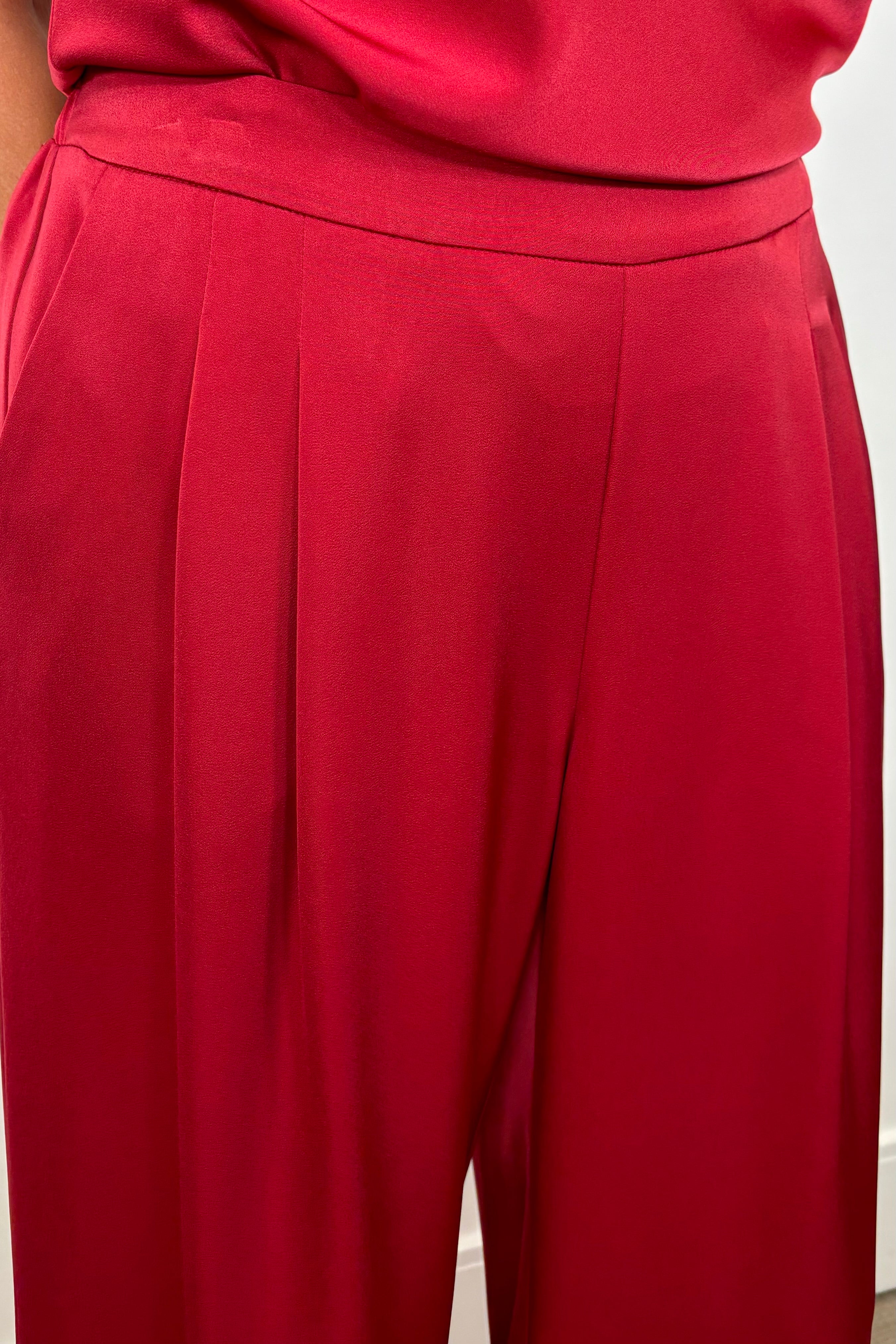 Close-up of woman wearing a satin red pant