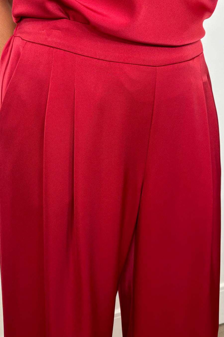 Close-up of woman wearing a satin red pant