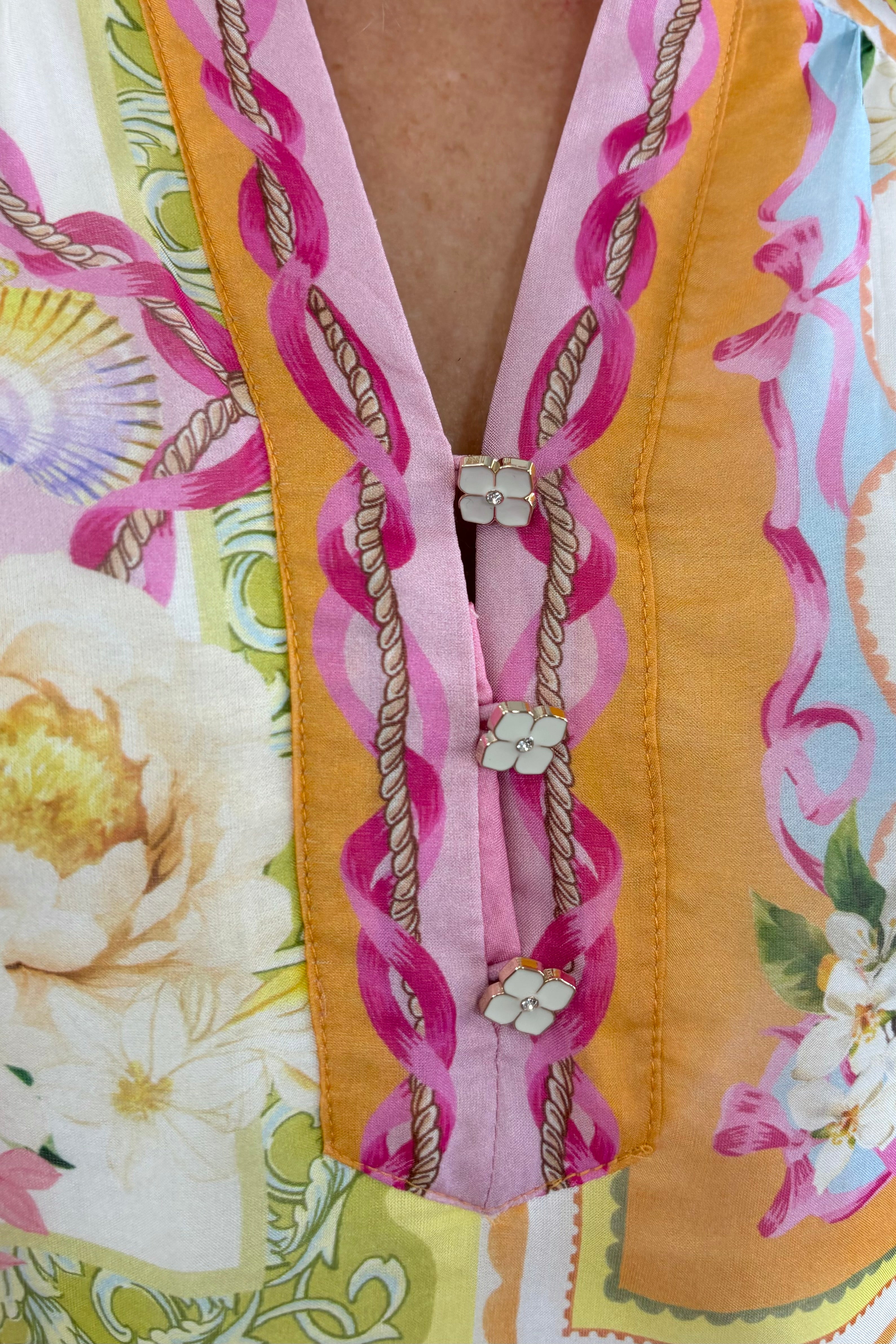 Close up of Woman wearing a warm colorful blouse with floral and butterfly print allover