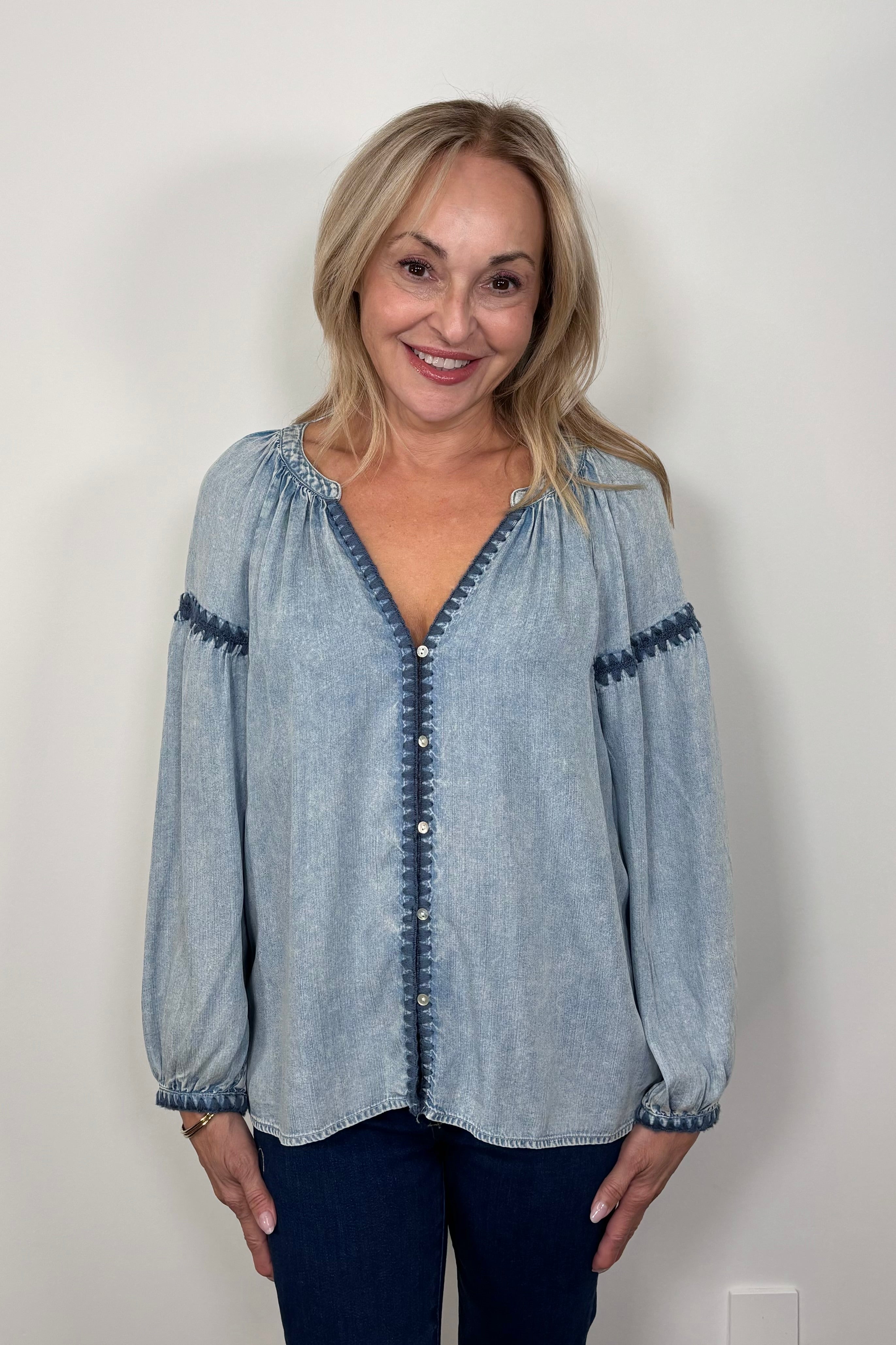Front view of woman wearing a blue tencel blouse with stitch detailing
