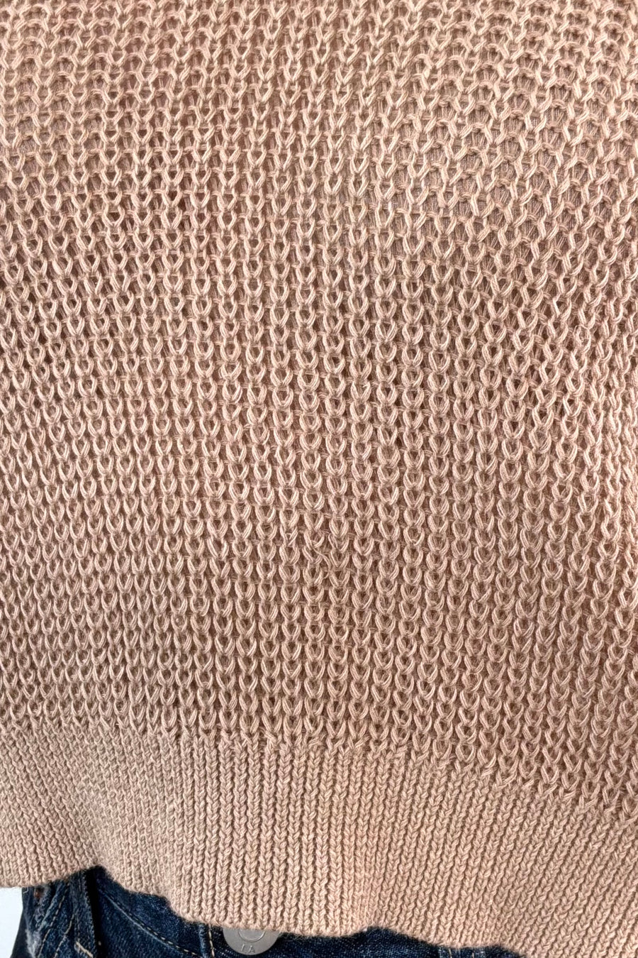 Close up of Woman wearing a light beige knit top