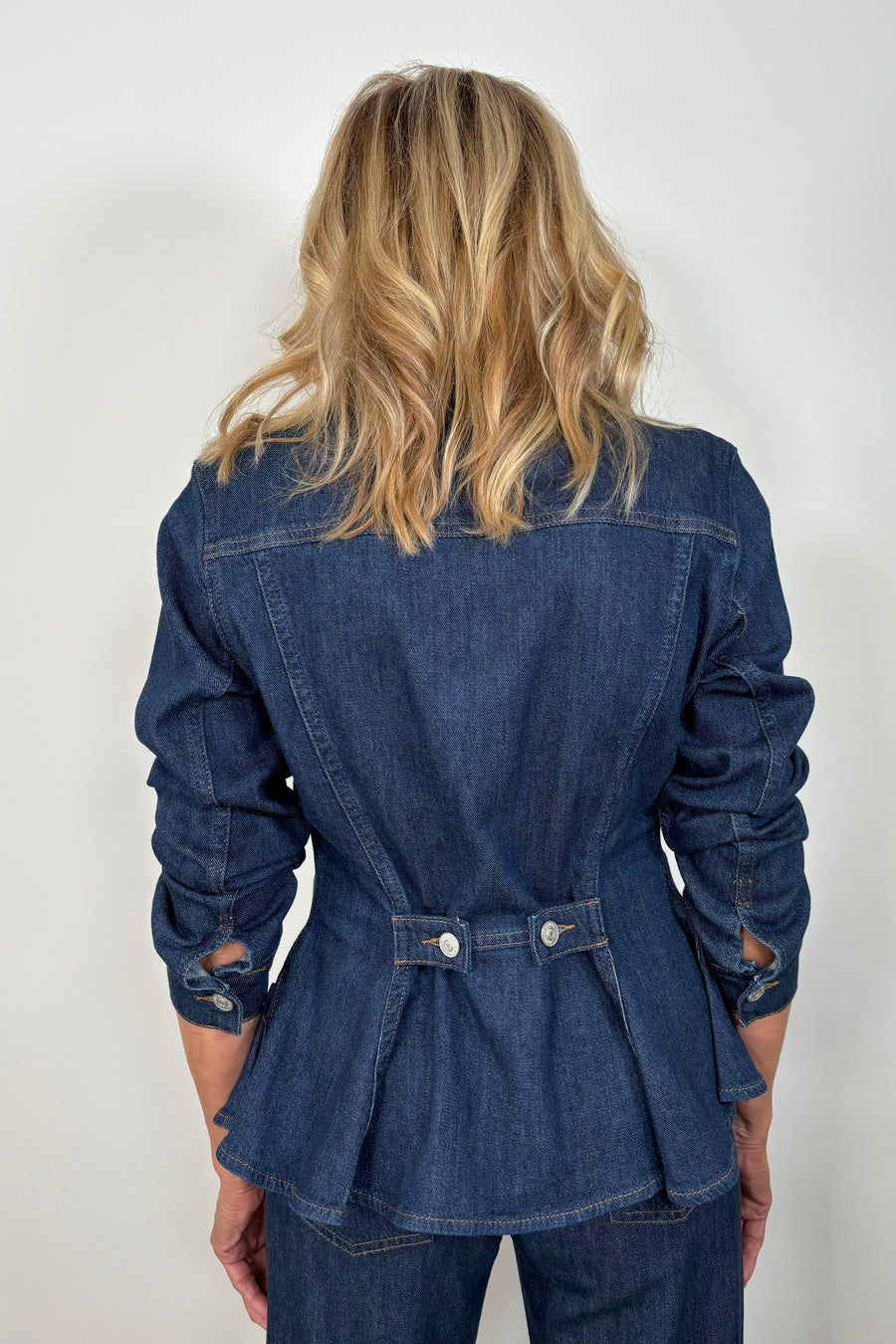 back view of woman wearing a fitted denim jacket