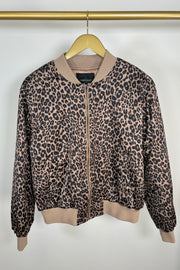 Front view of woman wearing a zipped up leopard print bomber jacket