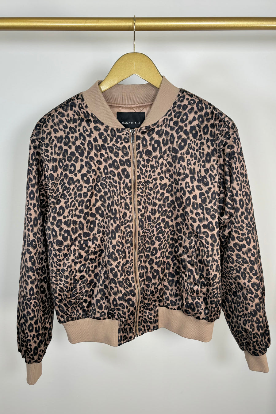 Front view of woman wearing a zipped up leopard print bomber jacket