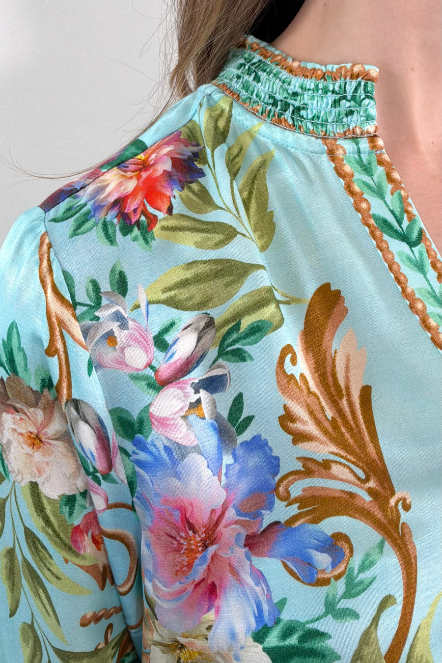 Close-up of a teal regency printed button down shirt