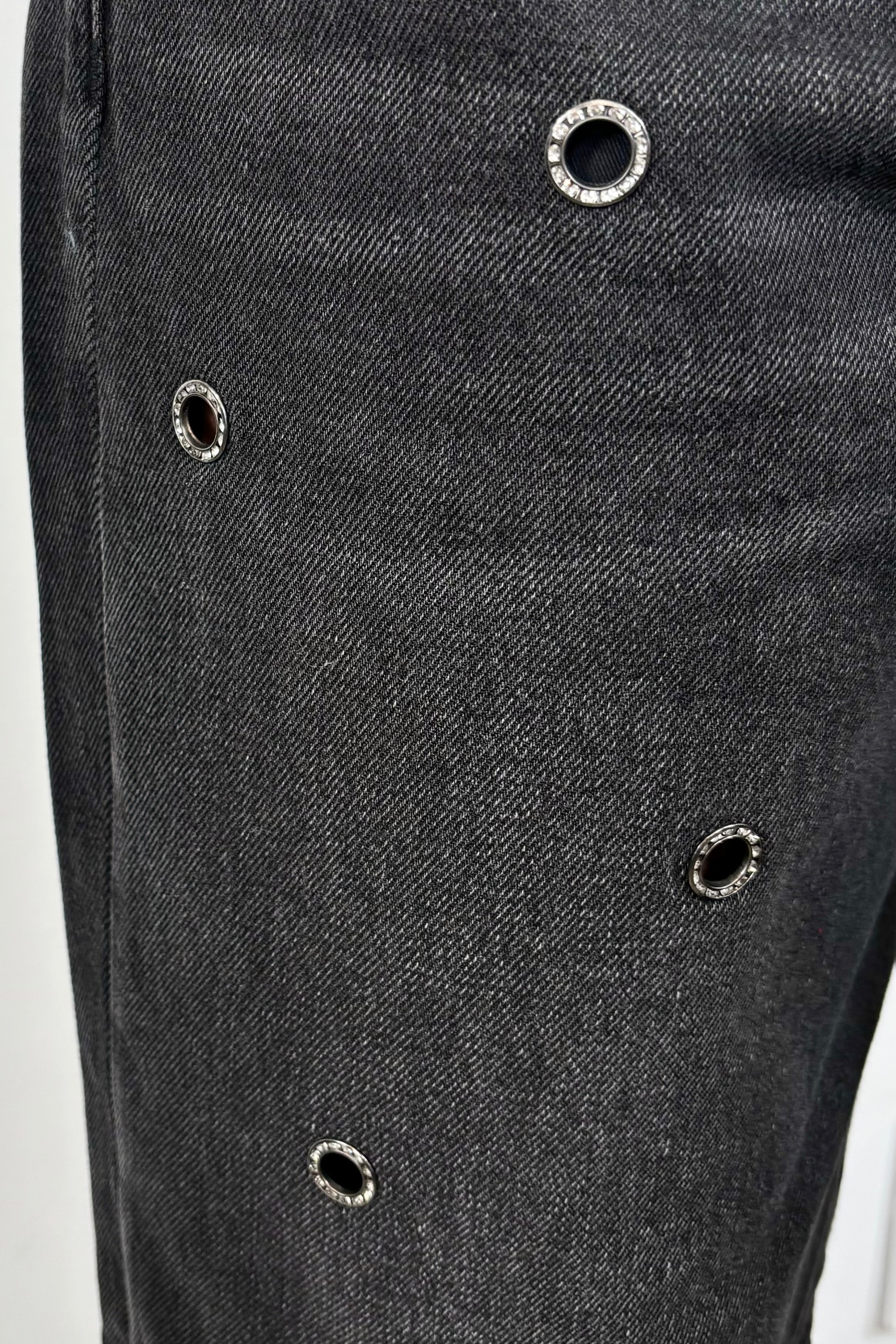 close-up of baggy jeans with metalware detailing