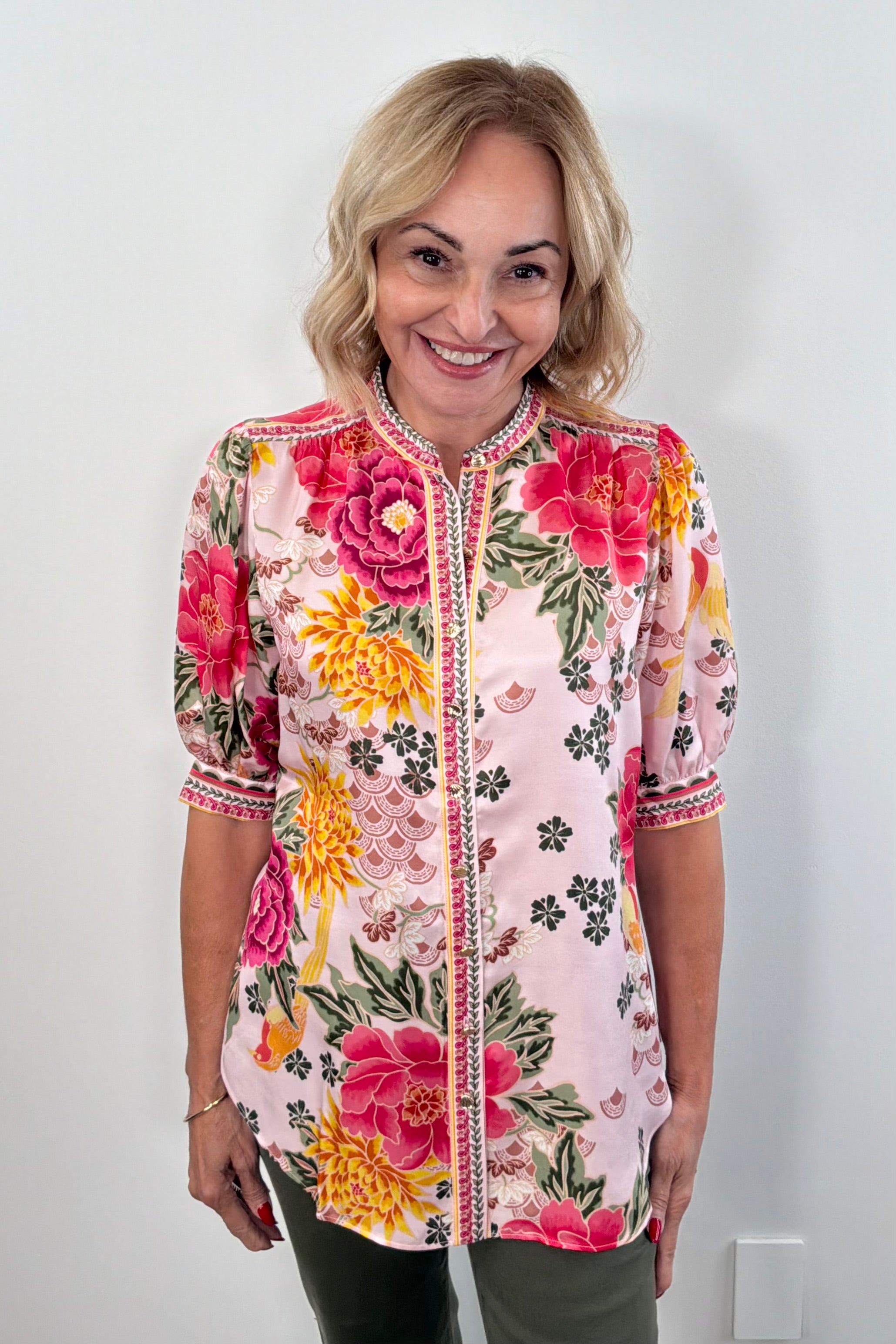 Woman wearing a colorful floral blouse top