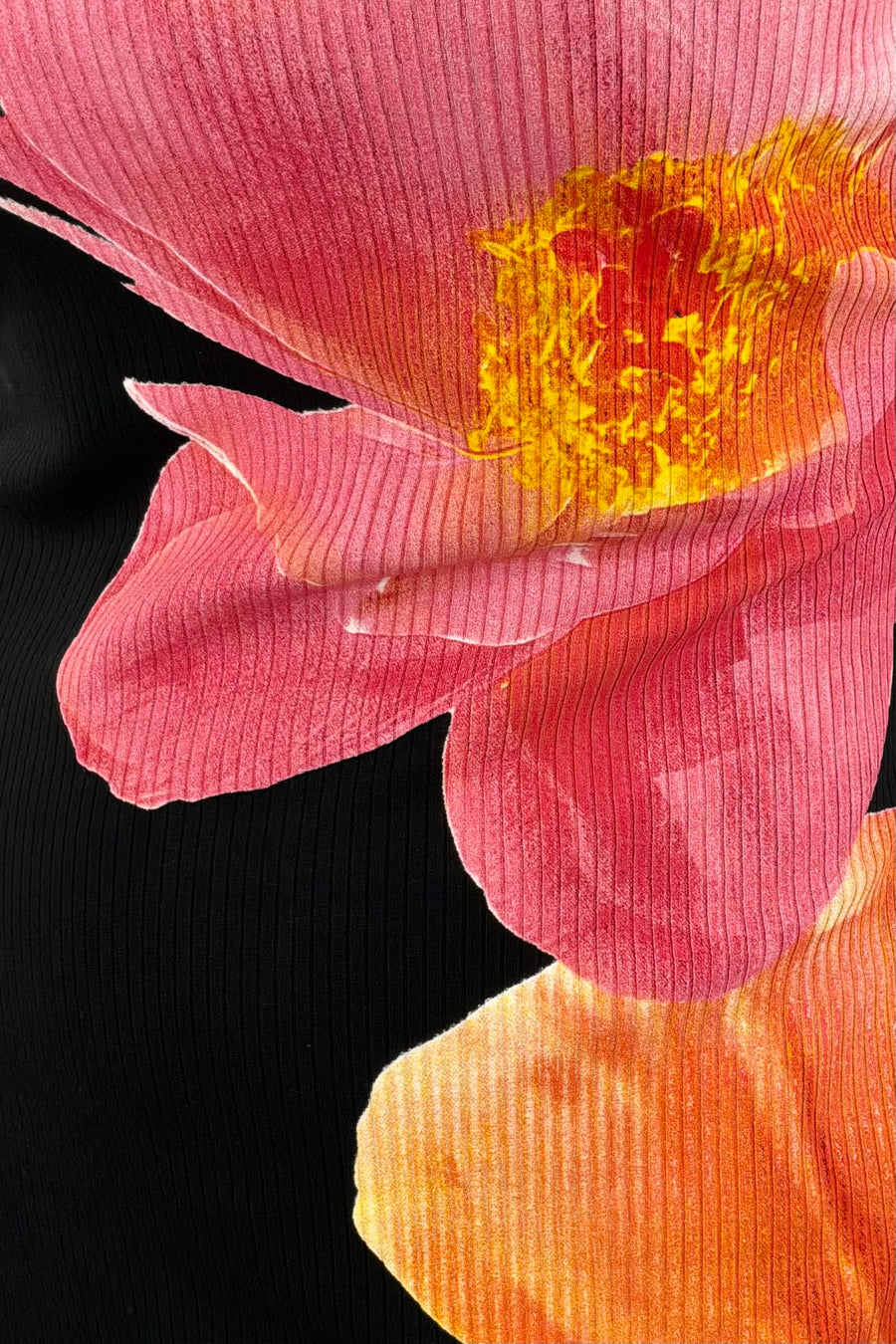 close-up of a midi black dress with a two flower print
