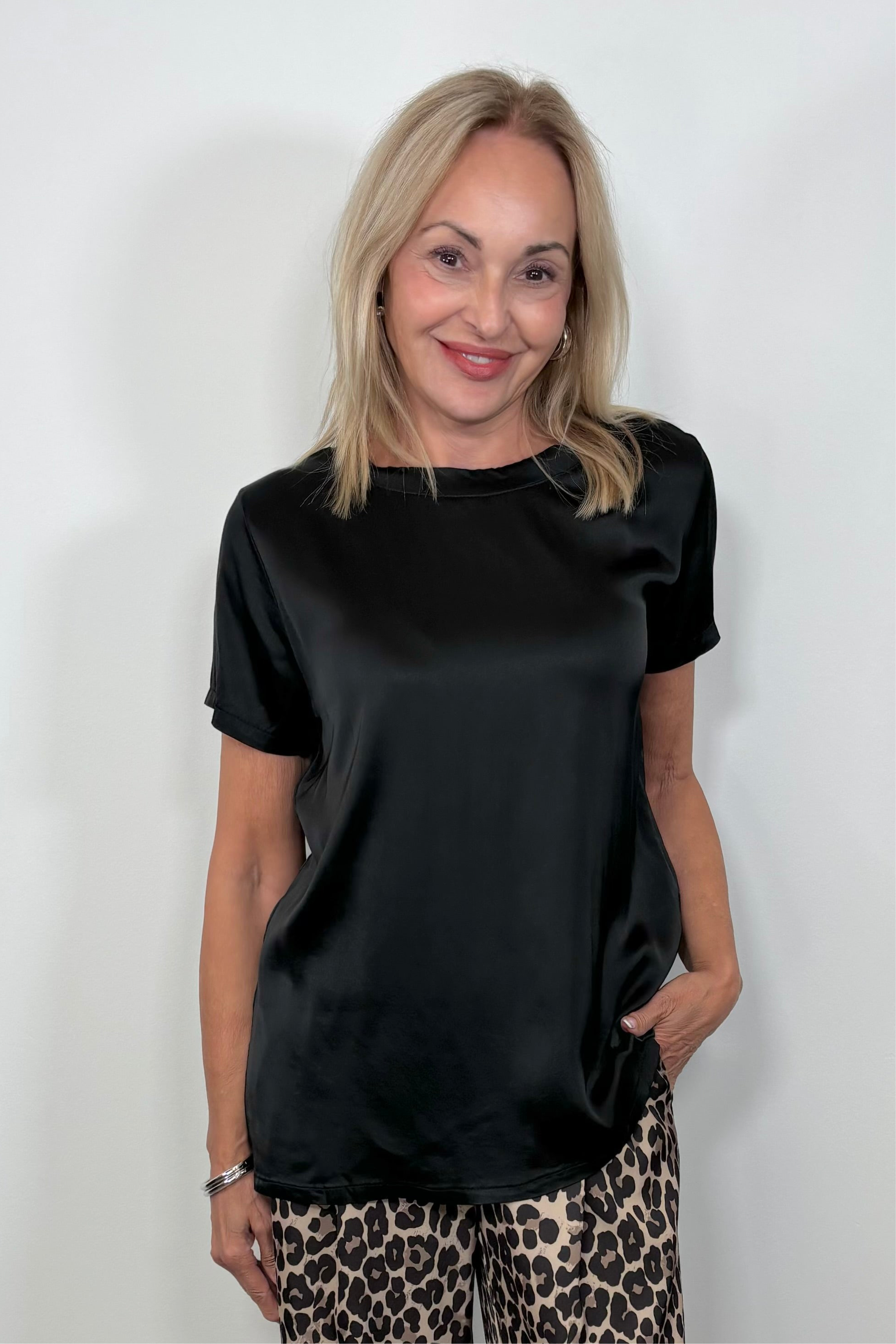 Front view of woman wearing a satin black shirt