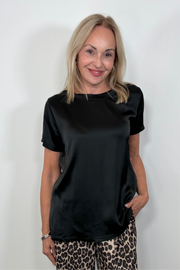 Front view of woman wearing a satin black shirt