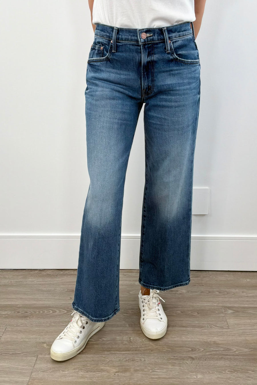 woman wearing wide leg mid rise washed blue denim