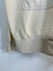 Close up of the bottom of a mix media bomber jacket 