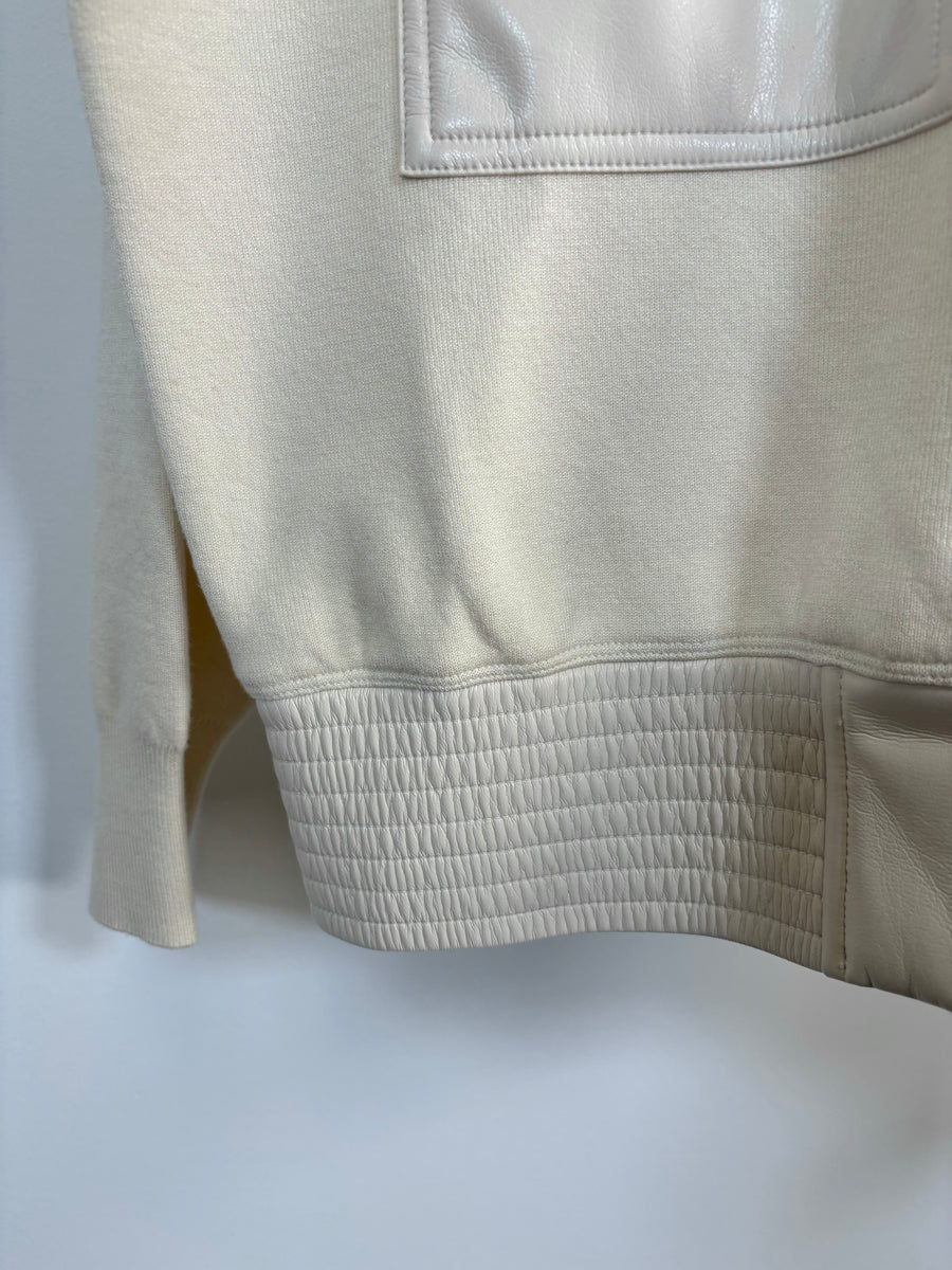 Close up of the bottom of a mix media bomber jacket 