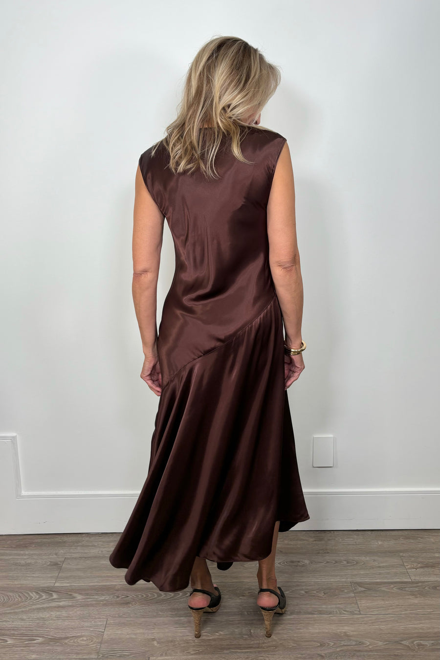 back view of woman wearing a chocolate brown satin dress