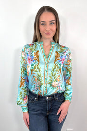 woman wearing a teal regency printed button down shirt tucked in