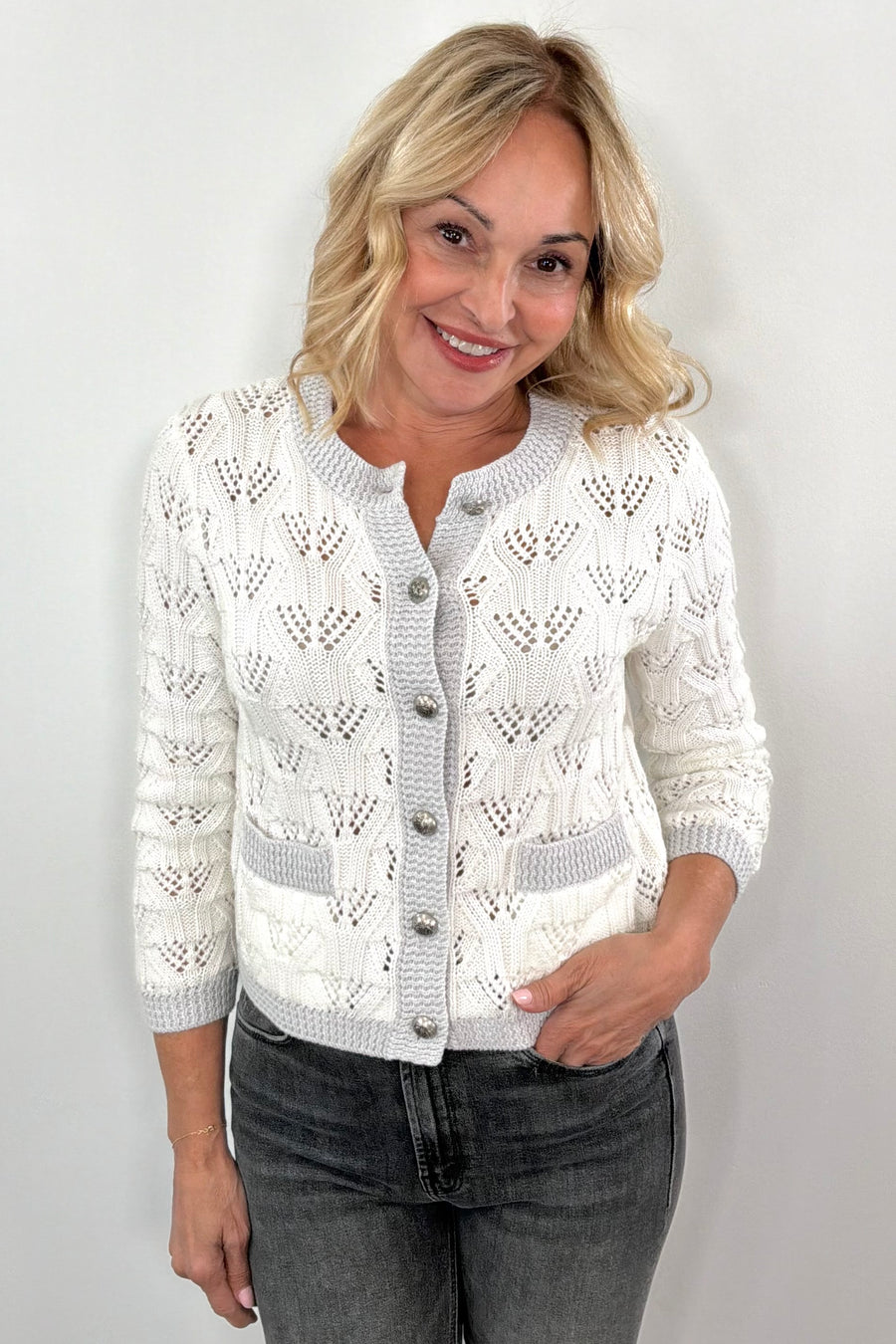 woman wearing a white 3/4 knitted button up cardigan 