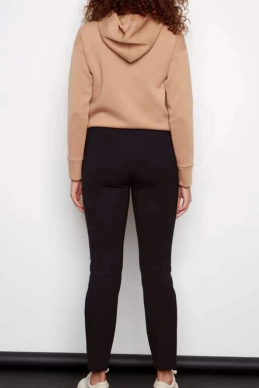 woman wearing black high waisted fitted pants 