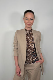 Front view of woman using a beige neutral stretch collarless ponte blazer