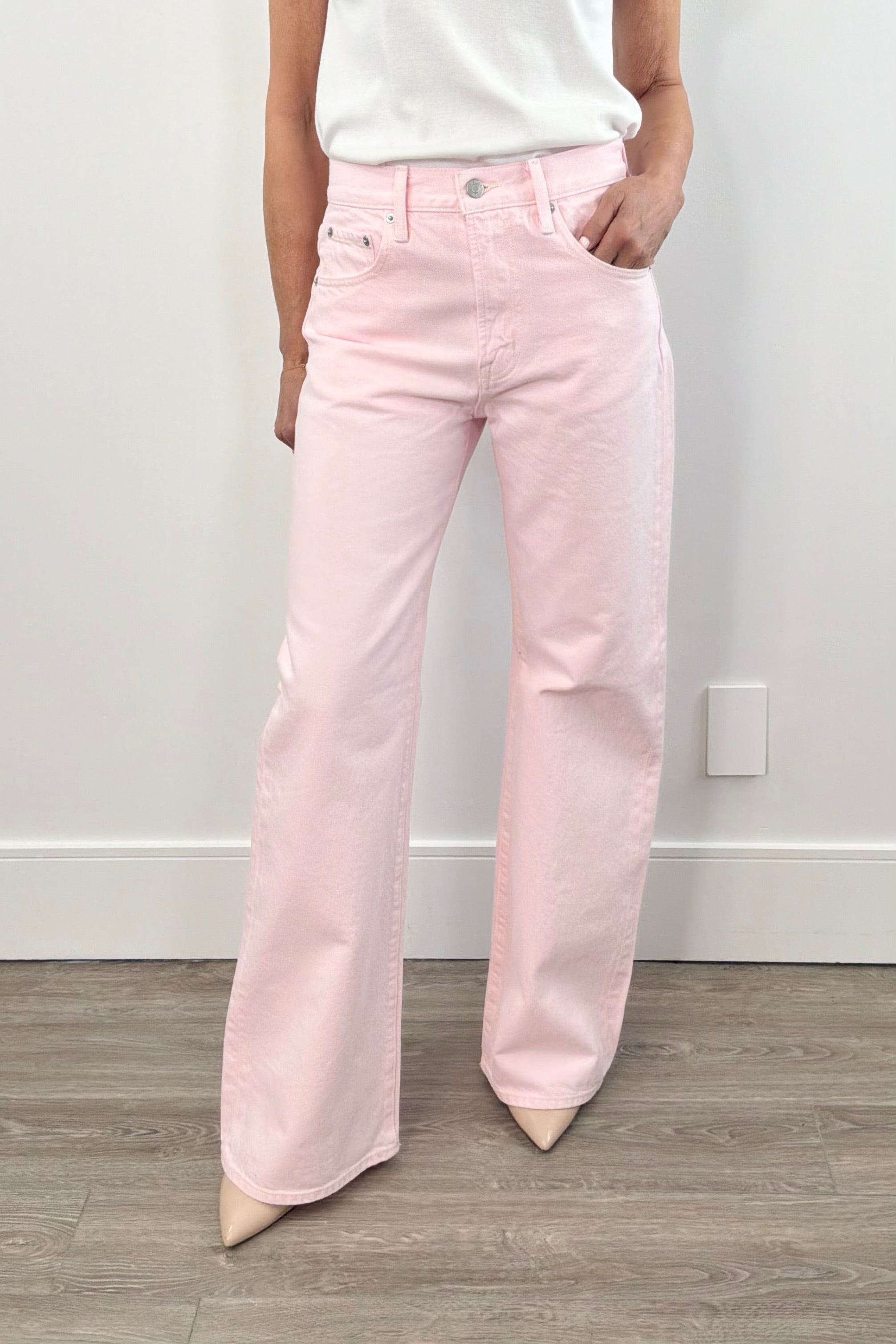 Woman wearing a light pink flare denim